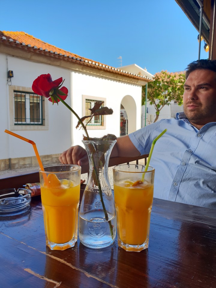 Breakfast in Portugal, albufeira, Algarve, handsome man, orange juice, red flower
